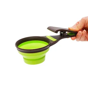 Functional collapsible green silicone pet food measuring scoop with a bag clip handle
