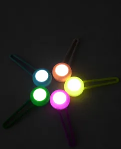 Detailed view of colorful LED glowing pet safety tags for night walking