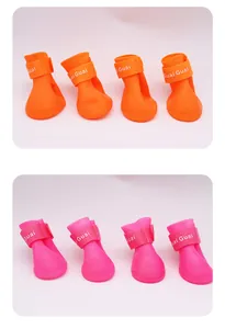 Set of orange and pink waterproof silicone dog rain boots with secure velcro straps