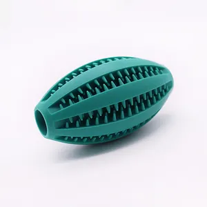 Durable green rubber rugby dog chew toy for teeth cleaning and treat dispensing