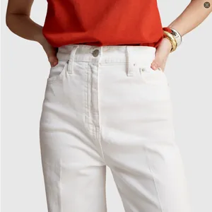 Close-up detail of high-waisted white wide-leg denim jeans showing fit and texture
