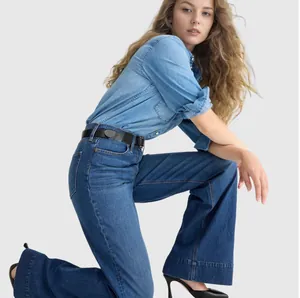 Detail view of stylish women's dark blue wide-leg denim jeans with black belt accessory.