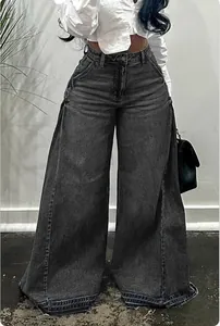 Close-up of women's dark wash high-waisted wide-leg jeans with a raw distressed hem.
