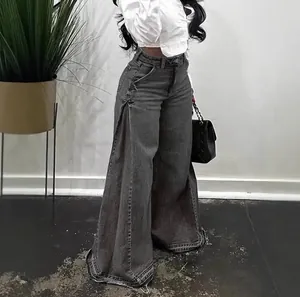 Stylish women's grey washed wide-leg flared jeans with side slits and trendy raw fringed hems