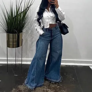 Trendy women's blue washed wide-leg flared denim jeans with stylish frayed tassel hem