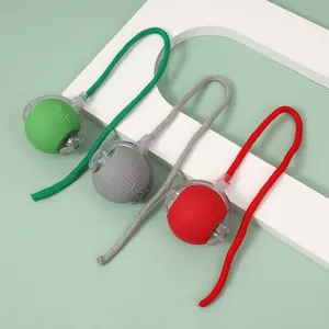 Three interactive silicone pet toy balls with ropes in green, grey, and red colors