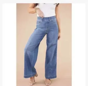 Detailed view of women's vintage high-waisted wide-leg blue jeans with front seam details.