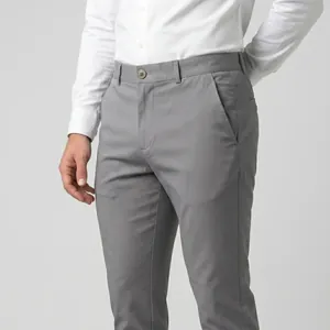 Close-up detail of grey high-stretch men's business trousers featuring a slim fit cut
