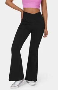 Detailed view of women's black high-waisted flared pants with crossover waistband