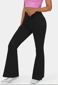 Detailed view of black high-waisted flare leggings with cross-over waist design