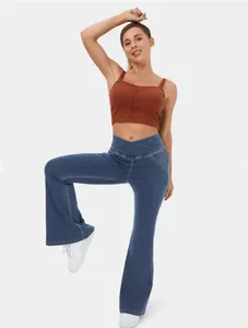 High stretch blue denim flare pants featuring a unique crossover waist design on model