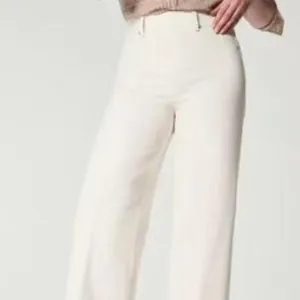 High waisted cream-colored wide-leg trousers for women in a loose retro fit style