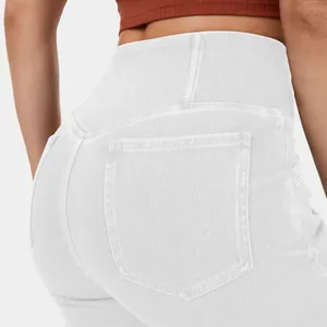 Close-up of high-waisted white denim flare pants showing back pockets and stretchy fit.