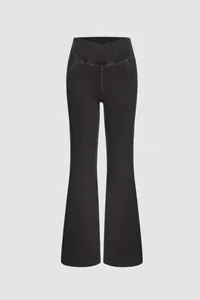 High waisted black flare leggings with elastic denim texture and cross-over waist