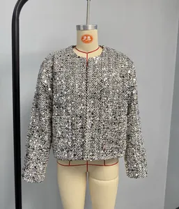 Close-up of elegant sequined tweed jacket with round neck and shimmering silver details