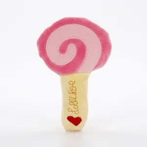 Close-up detail of the vibrant pink and yellow lollipop-shaped plush squeaky pet dog toy