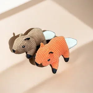Detail shot of durable corduroy plush pet toys in orange and brown animal shapes