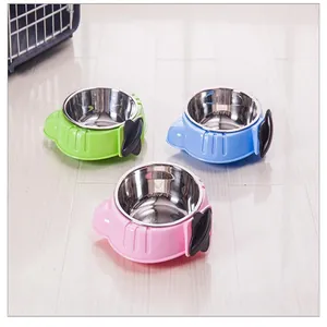 Detail view of colorful stainless steel cage-mounted pet bowls in green blue and pink