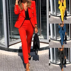 Detailed view of the elegant double-breasted blazer and pants suit in vibrant red.