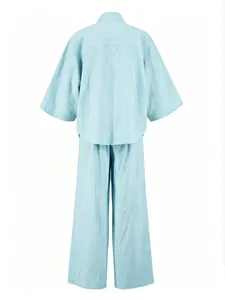 Back view of light blue loose linen-blend two-piece shirt and wide-leg pants set