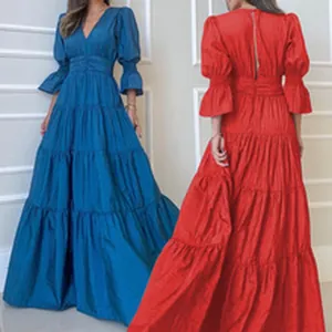 Elegant long-sleeved tiered maxi dress with lantern sleeves and pleated waist detail.