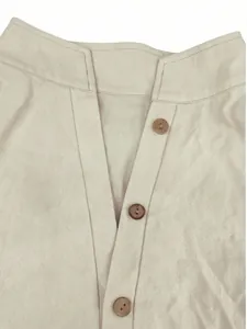 Close-up detail of a minimalist linen shirt collar featuring brown wooden buttons.