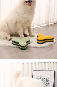 Grand chien blanc assis à côté de gamelles puzzle en forme de Y colorées