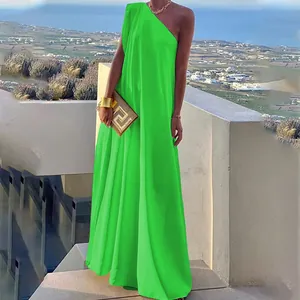 Detail showing the fluid drape of a vibrant green one-shoulder sleeveless maxi dress.