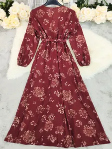 Back view of a vintage bohemian maxi dress with floral print on burgundy fabric