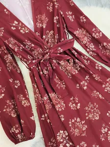 Close-up of bohemian floral print dress in burgundy with elegant wrap waist tie