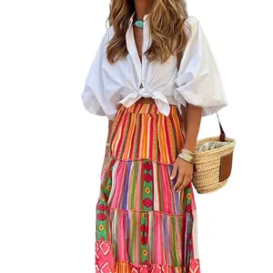 Full length view of a bohemian tiered maxi skirt styled with a white puff sleeve shirt