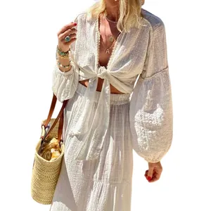 Detail of bohemian white tie-front puff sleeve top and high-waisted maxi skirt set