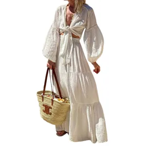 White bohemian two-piece set featuring puff sleeve crop top and tiered maxi skirt detail.