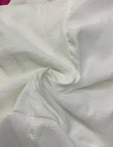 Close-up view of the breathable white bubble textured fabric for summer bohemian set