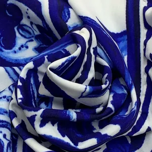 Macro detail of blue and white floral print fabric with a soft woven texture