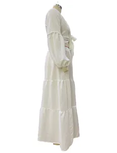 Side profile view of white Bohemian puff sleeve crop top and tiered maxi skirt set