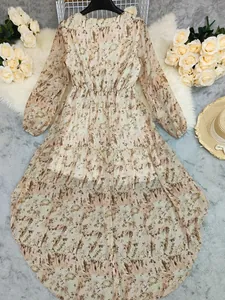 Detail of a bohemian V-neck long sleeve dress with irregular hem and abstract floral print