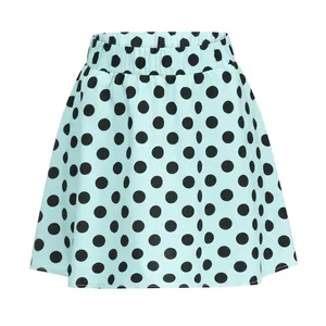Close-up view of mint green mini skirt with large black polka dots and elastic waist