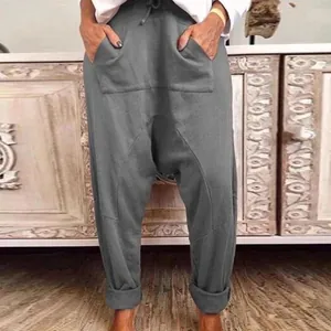 Casual women's grey drop-crotch harem pants with large front pockets and drawstring