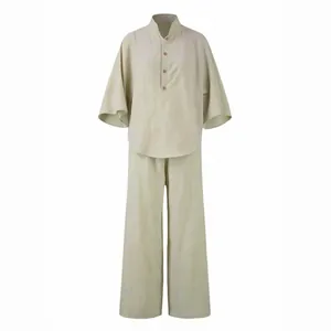 Two-piece beige linen style set featuring a flared sleeve shirt and loose wide-leg trousers