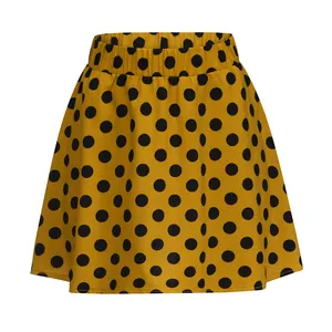 Detailed view of yellow mini flared skirt featuring classic black polka dot pattern for summer