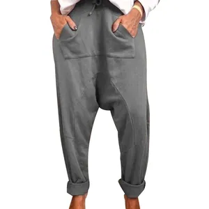 Detailed front view of grey women's drop crotch harem pants with drawstring waist.