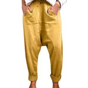 Detailed view of women's yellow casual drop crotch harem pants with drawstring and large pockets