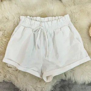 Detail view of white cotton linen summer shorts with elastic waist and drawstring