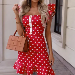 Detailed view of red polka dot mini dress with ruffle flutter sleeves and buttons