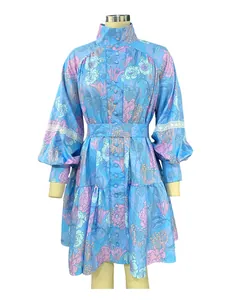 Detailed front view of a blue floral shirt dress with high collar and lantern sleeves