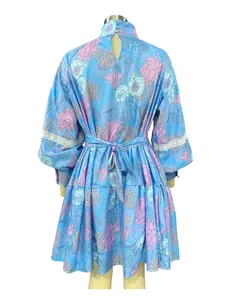 Back view of women's high-neck floral print shirt dress with waist tie and lace detail