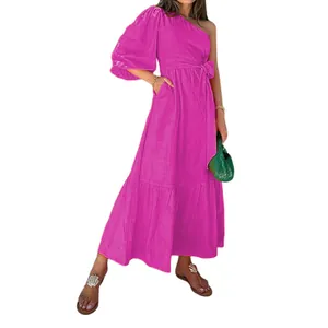 Detailed view of magenta one-shoulder cotton linen dress featuring waist tie and pocket