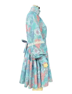 Side view of floral print shirt dress with high collar and flared skirt detail