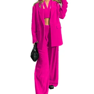 Vibrant fuchsia 3-piece suit featuring a blazer, crop top, and wide-leg trousers.